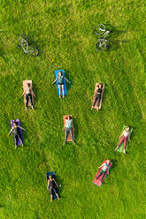 Aerial view of yoga group exercising in park. - AAEF12385