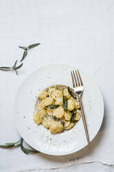 Plate of ready-to-eat Italian gnocchi dumplings with grated Parmesan cheese - SBDF04506