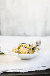 Plate of ready-to-eat Italian gnocchi dumplings with grated Parmesan cheese - SBDF04509