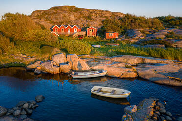 Aerial view of a small bay with red boat houses and boats in H√∂n√∂, Gothenburg Archipelago, Sweden, Scandinavia - AAEF12629