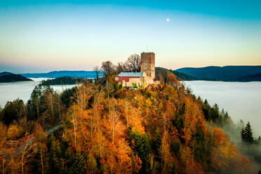 Panoramic aerial sunset view of the castle Yburg with floating fog in autumn, Varnhalt, Black Forest, Baden Baden, Baden Wine Route, Germany. - AAEF12662