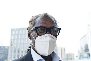 Businessman wearing eyeglasses and protective face mask - ASGF00922