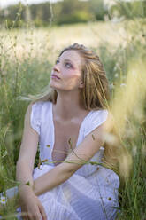 Young woman day dreaming in agricultural field - EIF01855