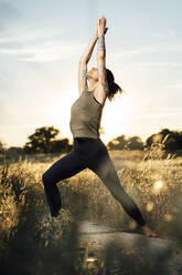 Woman doing yoga at countryside - DAMF00888