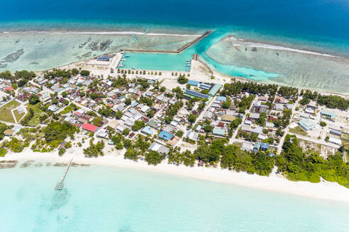 Panoramic aerial view of the local, inhabited island of Vashafaru with lagoon, reef, harbour, Maldives. - AAEF12688