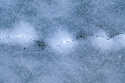 Luftaufnahme der zugefrorenen Neman-Flussmündung im Kauno-Mariu-Nationalpark mit einem Riss im Eis im Frühjahr, Kaunas, Litauen. - AAEF12815
