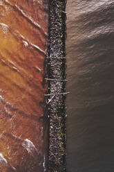 Aerial view of old pier made of wood and stones in Baltic sea, Sventoji, Lithuania. - AAEF12826