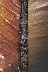 Aerial view of old pier made of wood and stones in Baltic sea, Sventoji, Lithuania. - AAEF12827