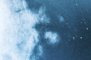 Aerial view of frozen lake ice surface texture in spring time near Trakai, Lithuania. - AAEF12883