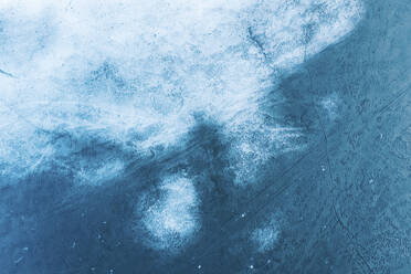 Aerial view of frozen lake ice surface texture in spring time near Trakai, Lithuania. - AAEF12884