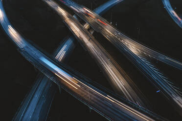 Aerial view of busy and fast highway traffic lights at night in Kaunas, Lithuania. - AAEF12895