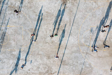 Kaunas, Lithuania - 18 April 2021: Aerial top down view of players shadows in urban basketball court in Kaunas, Lithuania. - AAEF12955