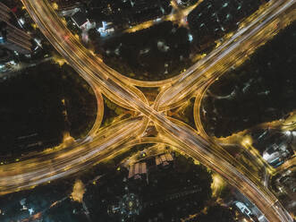 Aerial view of a complex road intersection with vehicles driving on the highway at night, Huangpu District, Shanghai, China. - AAEF13050