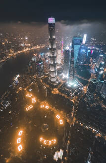 Aerial view of Shanghai skyline at night with financial district in background, Shanghai, China. - AAEF13055