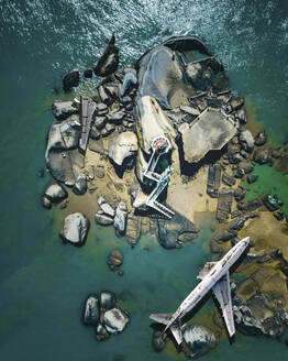 Aerial view of a commercial plane crashed on the ground along the river on the rocks, Xiamen, China. - AAEF13074