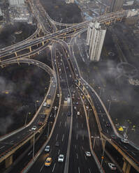 Aerial view of Rainbow road with complex intersection during a foggy day, Shanghai, China. - AAEF13087