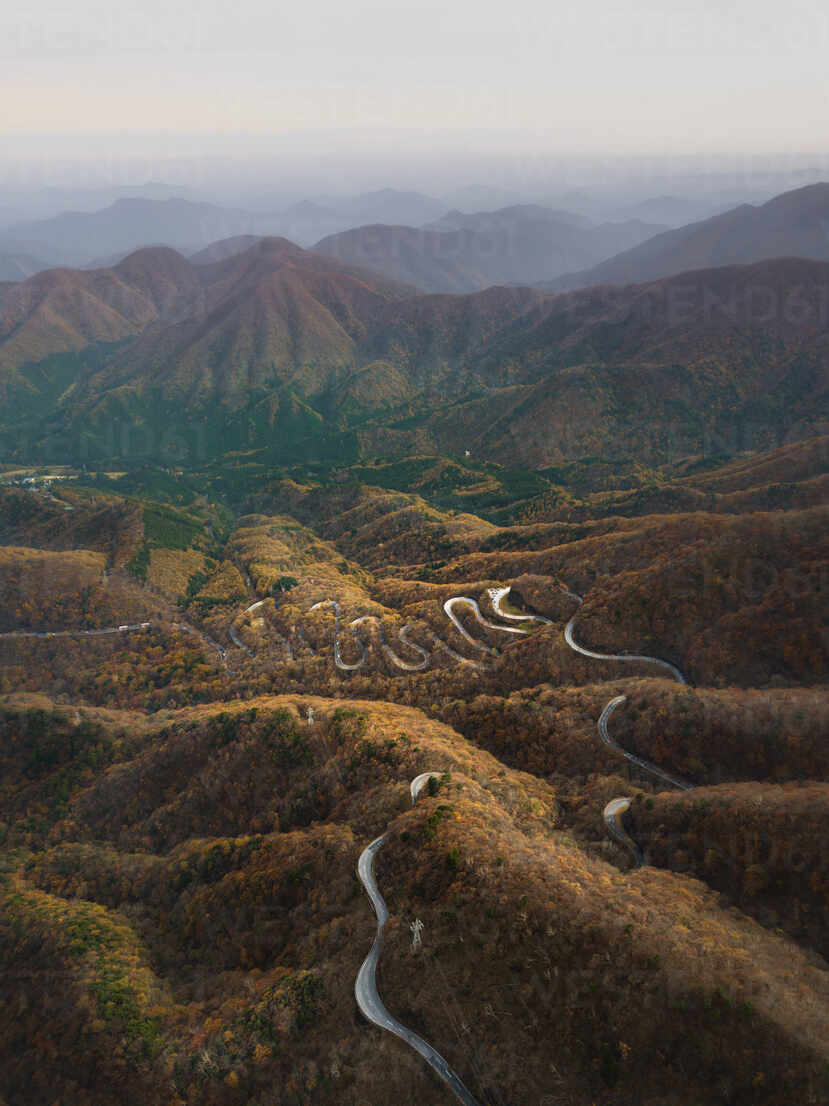 Aerial view of a scenic road on the hilltop crossing the mountains 