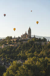 Spain, Castile and Leon, Segovia, Hot air balloons flying Segovia Cathedral and Alcazar of Segovia - JAQF00690