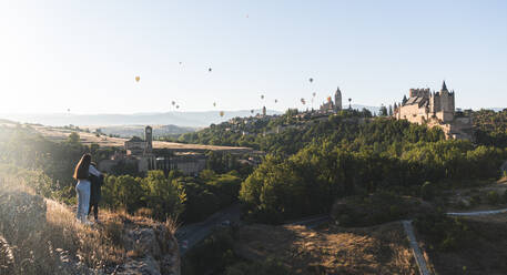 Spain, Castile and Leon, Segovia, Hot air balloons flying Segovia Cathedral and Alcazar of Segovia - JAQF00694