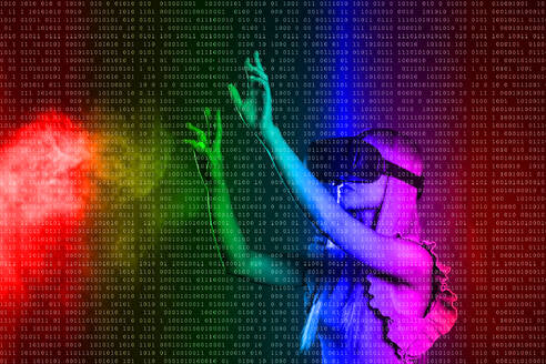 Junge Frau trägt einen Virtual-Reality-Simulator und gestikuliert vor einem farbigen Hintergrund - EIF01922