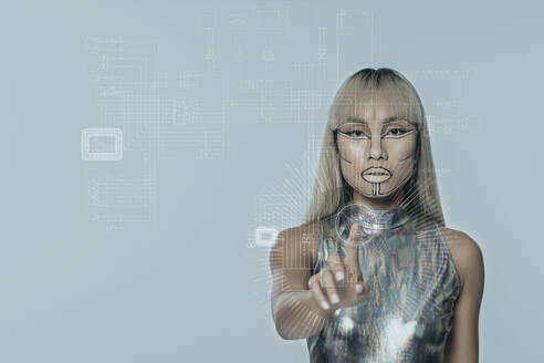 Robotic young woman with bangs touching interface against blue background - EIF01957