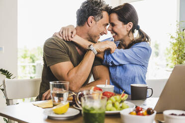 Man and woman embracing each other at home - UUF24490
