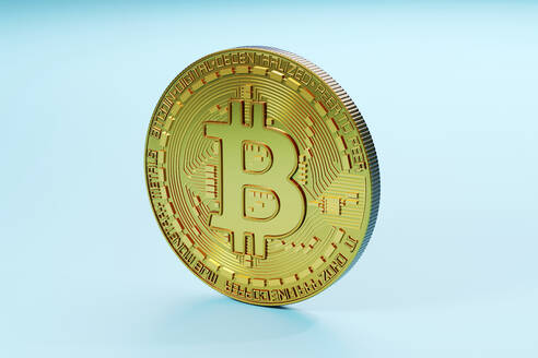 Three dimensional render of Bitcoin standing against blue background - SPCF01541