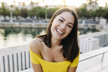 Happy young woman in front of sea - XLGF02185