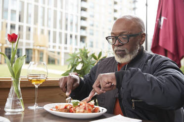 Man eating food at restaurant - PMF02055