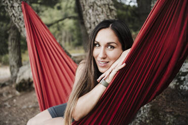 Beautiful woman sitting on hammock during vacation - EBBF04568