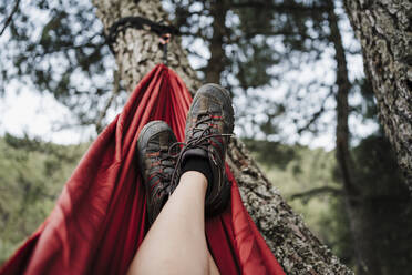 Woman with feet up relaxing on hammock - EBBF04572