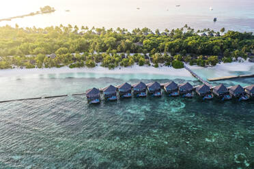 Maldives, Lhaviyani Atoll, Kuredu, Aerial view of coastal beach and row of resort bungalows - AMF09251