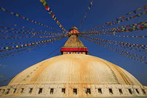 Nepal, Bagmati Province, Kathmandu, Prayer flags hanging from top of Boudhanath stupa - EAF00043