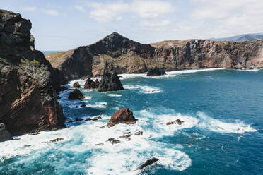 Waves of the Atlantic Ocean crashing on rocky cliffs, Sao Lourenco Peninsula, Canical, Madeira island, Portugal, Europe - RHPLF20655