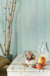 Studio shot of jar of healthy muesli with raw fruits and nuts - ASF06765