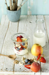 Studio shot of jar of healthy muesli with raw fruits and nuts - ASF06766