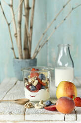 Studio shot of jar of healthy muesli with raw fruits and nuts - ASF06767