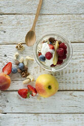 Studio shot of jar of healthy muesli with raw fruits and nuts - ASF06768