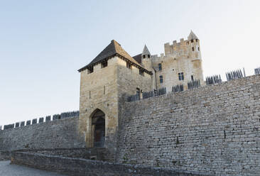 France, Dordogne, Beynac-et-Cazenac, Entrance gate of Chateau de Beynac at sunset - GWF07137