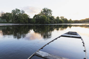 Sunken boat left at bank of Dordogne River at sunset - GWF07162