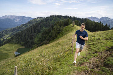 Man running on mountain trail - DIGF16354