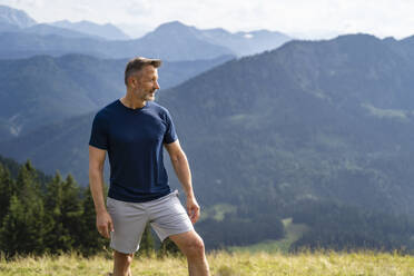 Thoughtful man standing on mountain - DIGF16359