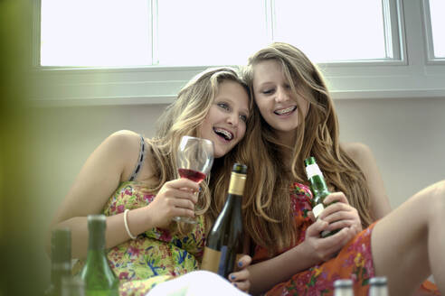 Girls having drinks while sitting at home - AJOF01593