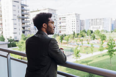 Thoughtful male professional standing at balcony - MEUF04098