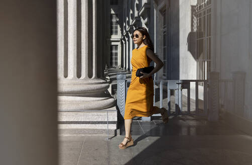 Woman running through arcade at National Gallery, Singapore - EAF00074