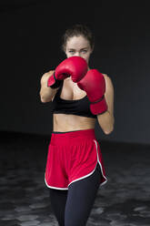 Weiblicher Boxer beim Sporttraining im Keller - EAF00092