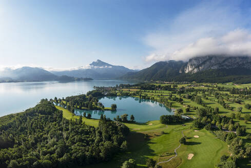 Drone view of golf course on shore of Mondsee lake in summer - WWF05779