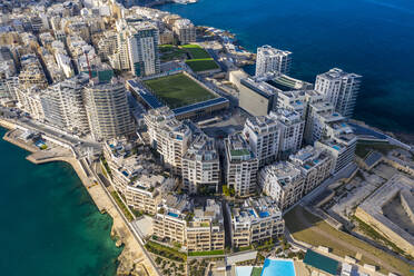 Malta, Central Region, Sliema, Aerial view of soccer field, apartments and hotels of Tigne Point peninsula - TAMF03213