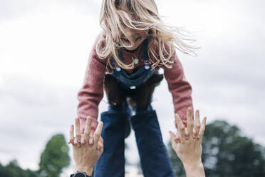 Cheerful daughter playing with father outdoors - ASGF01302