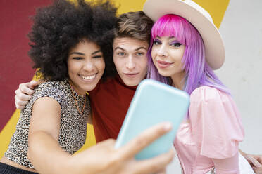 Smiling Afro woman taking selfie with friends - JCCMF03681
